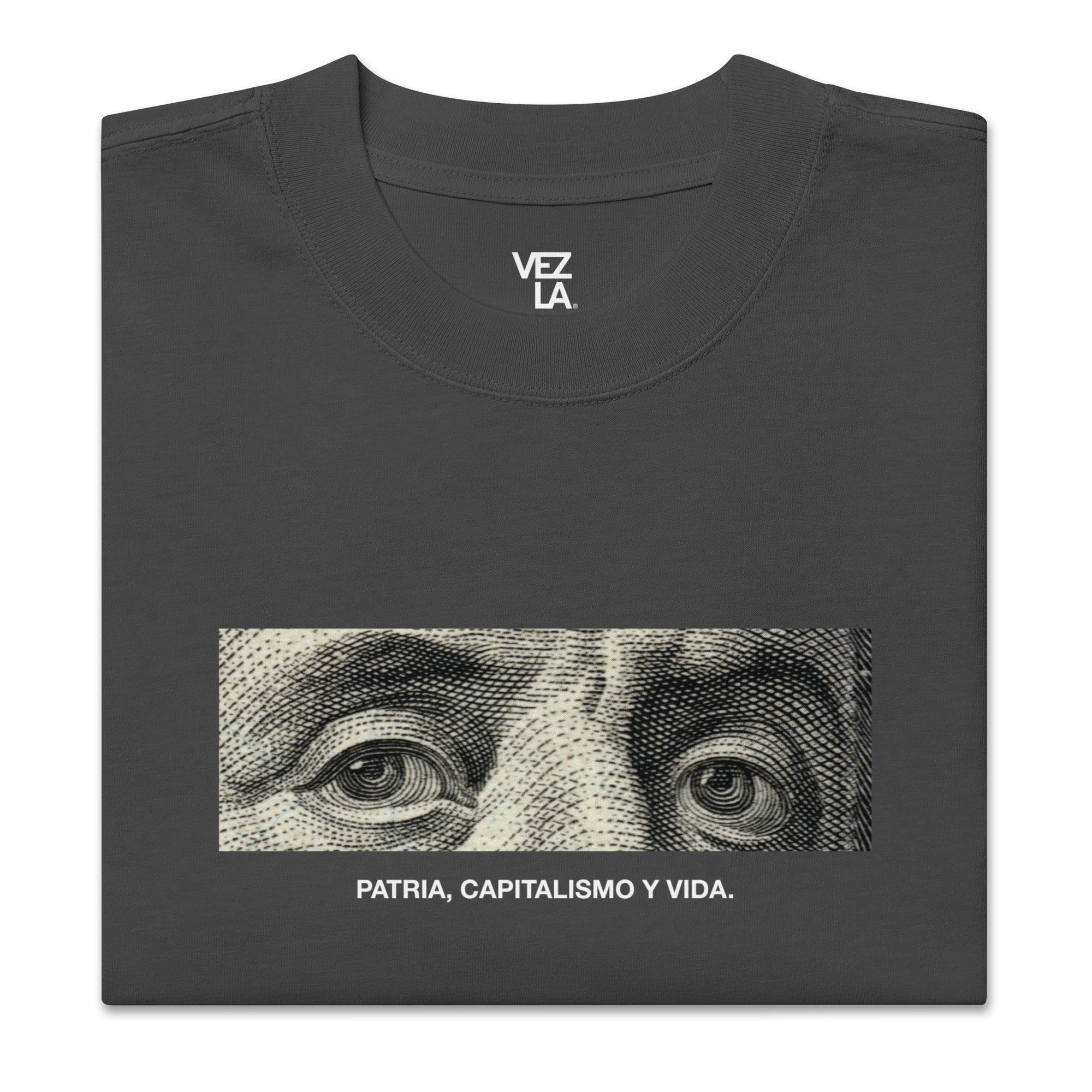 “Patria, Capitalismo y Vida” oversized faded tee in faded black, folded detail — Venezuelan political humor #color_faded_black